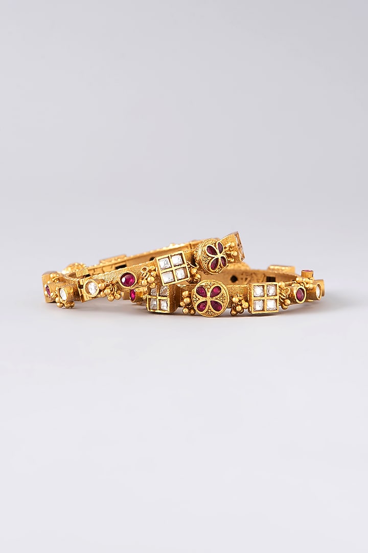 Gold Finish Kundan Polki & Red Stone Bangles (Set of 2) by VASTRAA Jewellery at Pernia's Pop Up Shop